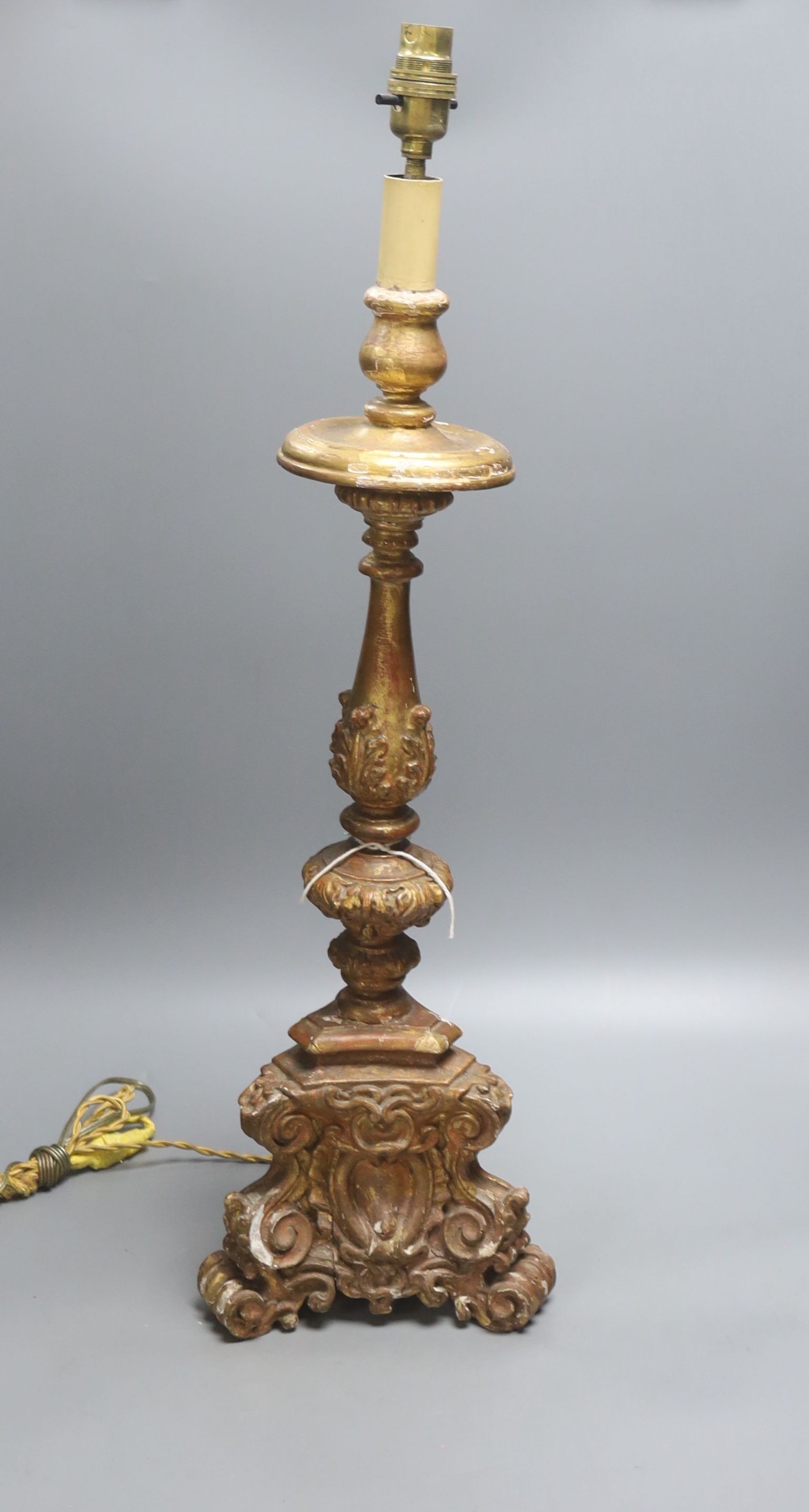 A late 19th century Italian Baroque style giltwood and gesso candlestand